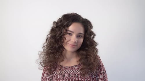 Smiling Young Adult with Curly Brown Hair
