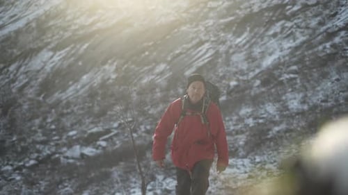 Hiker Walking Up Snowy Mountain Foothill