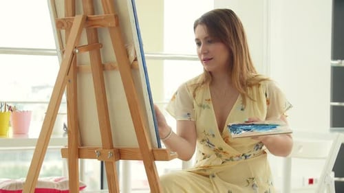 Woman Painting on Canvas in Studio