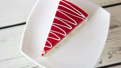 Slice of Red Drizzled Cake on White Plate