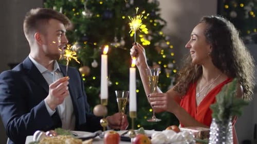 Couple Celebrating Holidays with Sparklers and Champagne