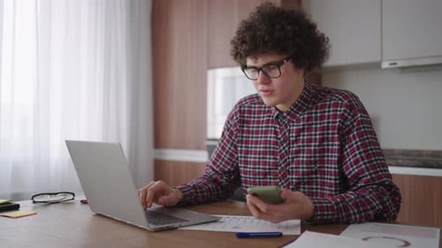 Young Adult Working at Home with Laptop