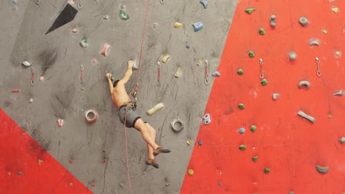 Man Climbing Indoor Rock Wall for Fitness