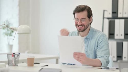 Man Reviews Documents and Receives Good News