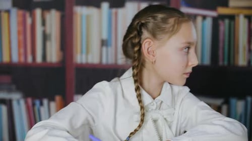 School Girl Studying in Classroom