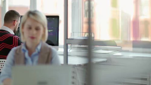 Man and Woman Working Together in Modern Office
