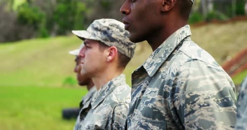 Soldiers in Camouflage Uniforms Stand in a Line