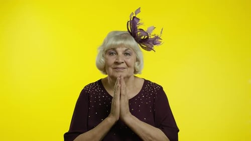 Elegant Senior Woman Hopeful Expression on Yellow Background
