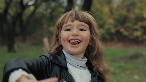 Happy Little Smiling Girl Portrait in the Forest