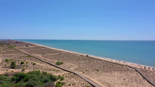 Aerial Drone Footage Shooting Beach Dunes with Wooden Paths to the Sea
