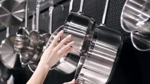 The Beautiful Woman Is Checking the Stainless Steel Tableware