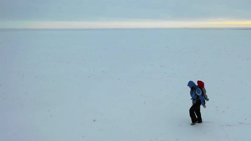 Man with Red Backpack Walking By the Tundra. Strength, Overcoming and Tough Travel Concept.