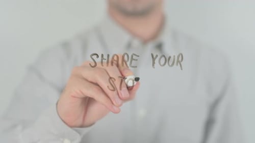 Man Writing Message on Clear Surface
