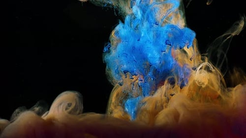 Close-up of flow of colored paints in water