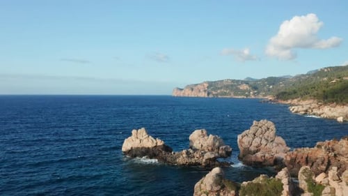 Aerial View of Rugged Rocky Coastline and Azure Sea