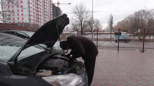 Man Looking For A Car Breakdown