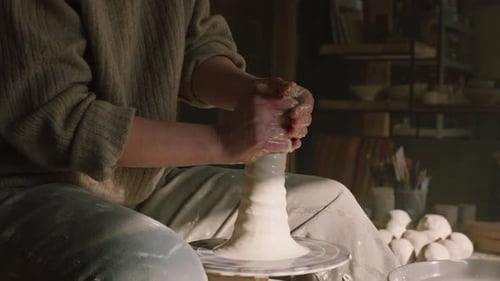 Hands Shaping Clay on a Pottery Wheel