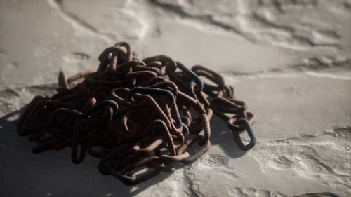 Pile of Rusty Metal Chains on Stone Ground