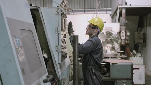 Maintenance engineer control automatic and pressing machine with panel in factory.