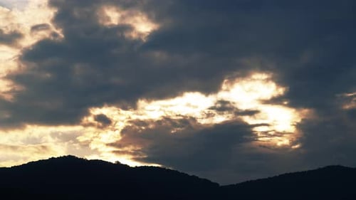 Timelapse of Clouds at Sunrise Over Mountains