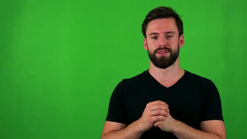 Young Handsome Bearded Man Talks To Camera - Green Screen - Studio