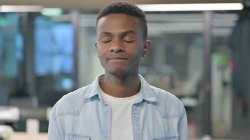 Young Adult Looking at the Camera in Office Setting