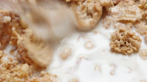 Mixing Cereal and Milk in Bowl Close Up