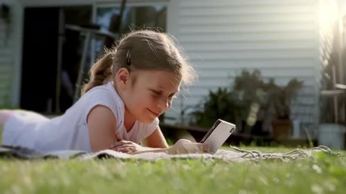 Close Up Shot of Carefree Girl is Playing on the Tablet