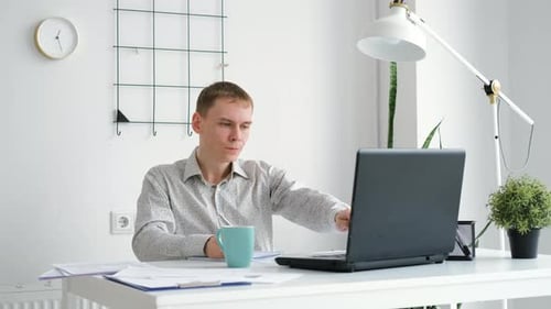 Confident Entrepreneur Working at Desk in Office
