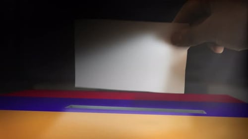Hand Drops Ballot into Election Box with Armenian Flag Colors