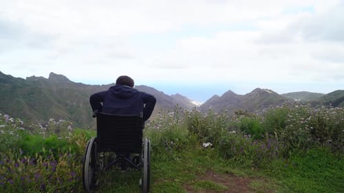 Disabled Handicapped Woman in Wheelchair on Mountain Hill Enjoying View