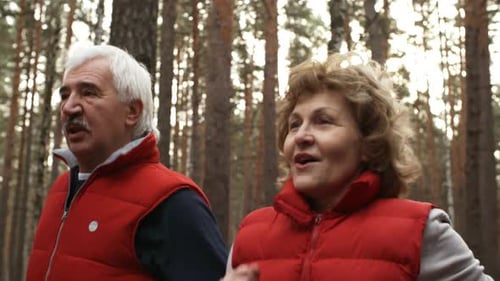 Senior Couple Jogging Through a Forest