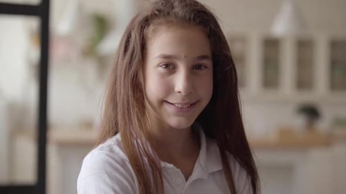 Smiling Girl Looking at the Camera at Home