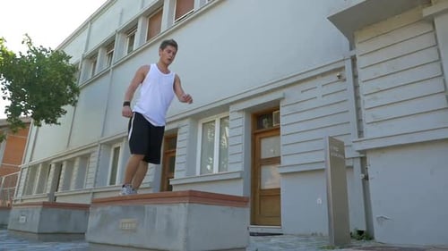 Man Performs Backflip Stunt in Urban Setting