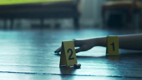 Dark Crime Scene with Evidence Markers and Arm