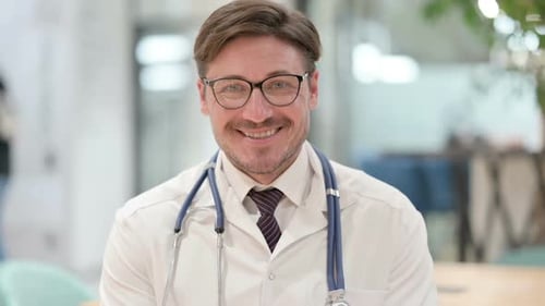 Portrait of Friendly Male Doctor Smiling At the Camera