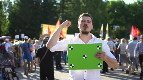 Man Protesting Holding Chroma Key Sign in Crowd