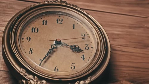 Old Retro Wall Clock with Moving Second Hand on Wooden Background