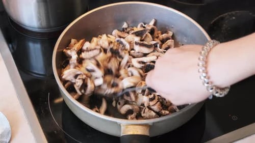 Mushrooms are Fried in a Pan in the Home Kitchen Cooking Mushrooms Julienne