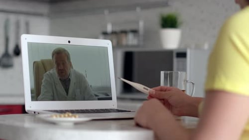 Woman on Telehealth Appointment with Doctor in Kitchen