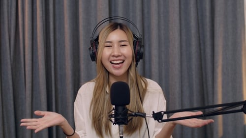 Woman Recording Podcast in Front of Microphone