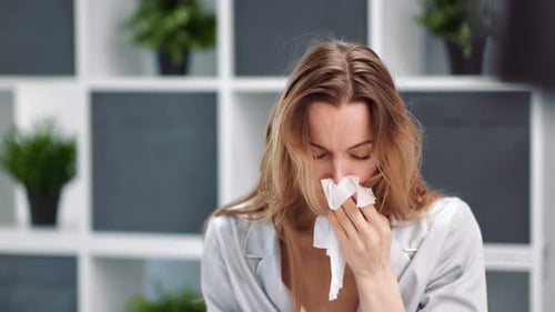 Woman Blowing Nose with Tissue, Feeling Ill