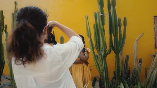 Stylish Model Posing Among Cacti in Vibrant Urban Setting