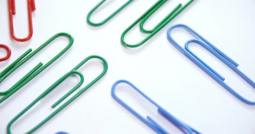 Colorful Paper Clips on a White Surface