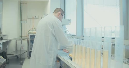 Scientist Working with Test Tubes in Modern Laboratory