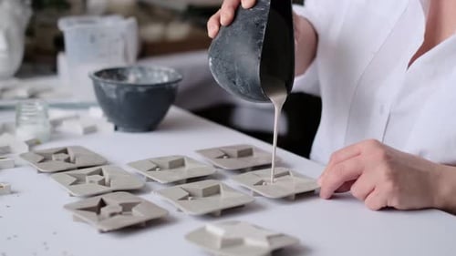 Woman pouring ceramic in an art studio