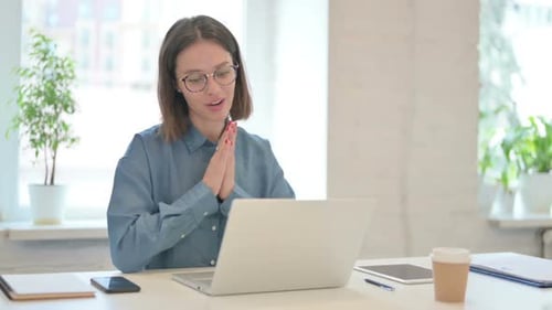 Woman On Video Call Using Laptop at Desk