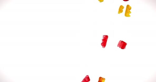 Colorful Gummy Bears Falling on White Background