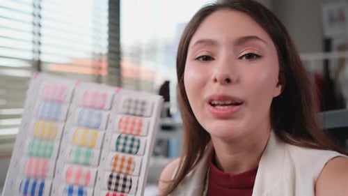 Close up face of woman designer or tailor selfie talk to camera and present cloth pattern