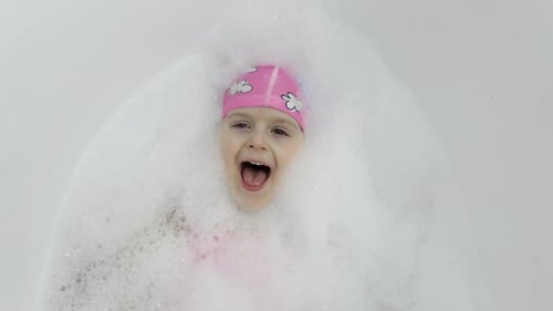 Happy Girl in a Tub of Foam Bubbles